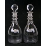 A pair of Georgian glass decanters of small proportions; together with enamel Port and Sherry bottle