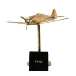 A WW2 brass model of the German Focke-Wulf FW190 with spinning propeller standing on its brass base,