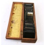 A quantity of 19th century magic lantern slides on various subjects, mainly nature, in a pine box