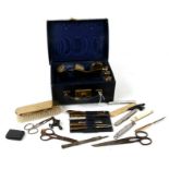 A vintage travelling vanity set, to include brass topped jars, manicure set and brush.