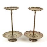 A pair of late 19th/early20th century silver plated two tier shop display stands, 36cm (14ins) high
