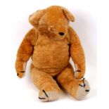 A vintage jointed teddy bear, 56cms (22ins) high.