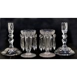 A pair of glass table lustres, 15cm (6ins) high; together with a pair of cut glass candlesticks,