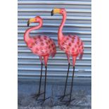 A pair of painted metal decorative garden flamingos, the largest 98cm (38.5ins) high.