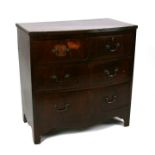 A mahogany bowfronted chest of two short and two long graduated drawers, 75cms (29.5ins) wide.