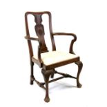 A Georgian style mahogany caver chair with shaped arms and drop-in seat, on acanthus leaf capped