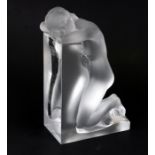 A Lalique Reverie glass book end depicting a frosted kneeling naked lady, 23cms (9ins) high.