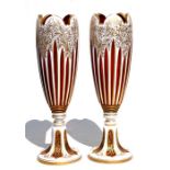 A fine pair of 19th century Bohemian cranberry glass overlaid vases with gilt decoration, 31cms (