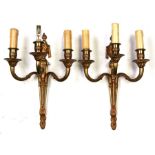 A pair of gilt bronze three-armed wall sconces, 36cms (14ins) high (2).Condition ReportMissing one