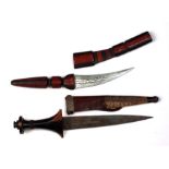 Two African tribal daggers in leather sheaths. Blade lengths of 15cms (5.875ins) and 22cms (8.
