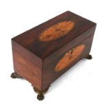 An early 19th century inlaid mahogany tea caddy with two lidded tea compartments and recess for