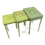 A nest of three painted occasional tables on faux bamboo legs, the largest 46cms (18ins) wide.