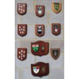 Assortment of ten military and heraldic shields and wall plaques, including two presented to Major