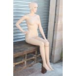 A life size seated female mannequin