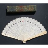 A Chinese export ivory fan decorated with figures in a landscape, in original box, 19cms (7.5ins)