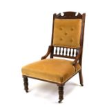 An Edwardian carved walnut chair with upholstered seat on back with turned front supports