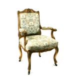 A French gilded armed chair with upholstered seat and back.