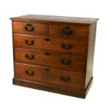 An Arts & Crafts pitch pine chest with two short and three long graduated drawers, on a plinth base,
