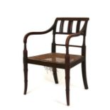 A Regency elbow chair with caned seat, on faux bamboo turned front supports.Condition Report