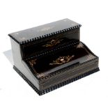A 19th century French ebonised writing box with stationary compartment and writing slope, inlaid