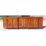 A pair of William Tillman Regency style breakfront side cabinets with an arrangement of four