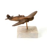 A brass model of a WW2 Supermarine Spitfire mounted on a marble base. Wingspan 14.5cms (5.75ins)