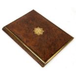 A Victorian figured walnut desk blotter with brass emblem to the Cold Stream Guards, 23 by 30cm (9