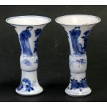 A pair of Chinese blue & white Kangxi gu vases, decorated with figures and flowers, blue leaf