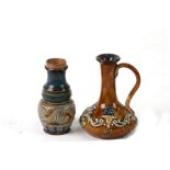 A Royal Doulton Stoneware miniature jug; together with a similar pepper pot, the largest 8cm (3.