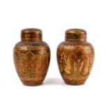 A pair of Persian or Kashmir lacquered vases and covers decorated with stylised flowers, 10cm (4ins)