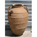 A large two handled terracotta olive jar, 60cm (23.75ins) high