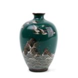 A Japanese cloisonne vase depicting birds in flight over a rough sea, on a green ground, 8cm (3.