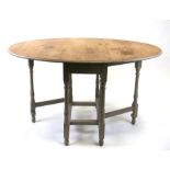 An oak gateleg table on distressed painted turned supports, 89cms (35ins) wide.