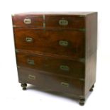 A 19th century teak military Campaign chest with two short and three long drawers, on turned feet,