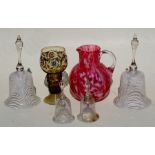 Two pairs of large and small Nailsea style glass table bells, the largest 26cm (10ins) high;