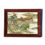 A framed Chinese porcelain panel depicting a palace with figures, 35 by 25cms (13.75 by 9.75ins).