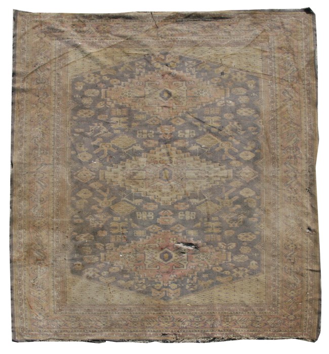 A Persian Shiraz rug with geometric design on a beige ground, 164 by 124cms.Condition Report Worn,