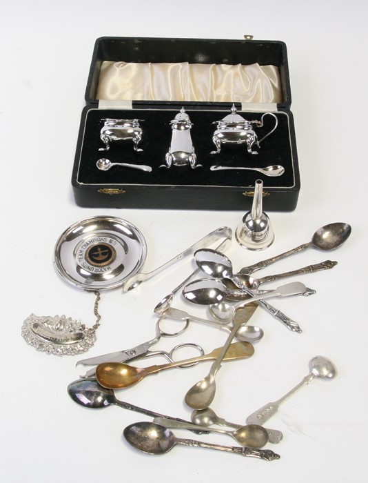 A boxed silver plated cruet set; together with souvenir spoons and other items.