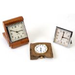 A Smiths travelling alarm clock; together with two similar (3). Condition ReportClock in leather