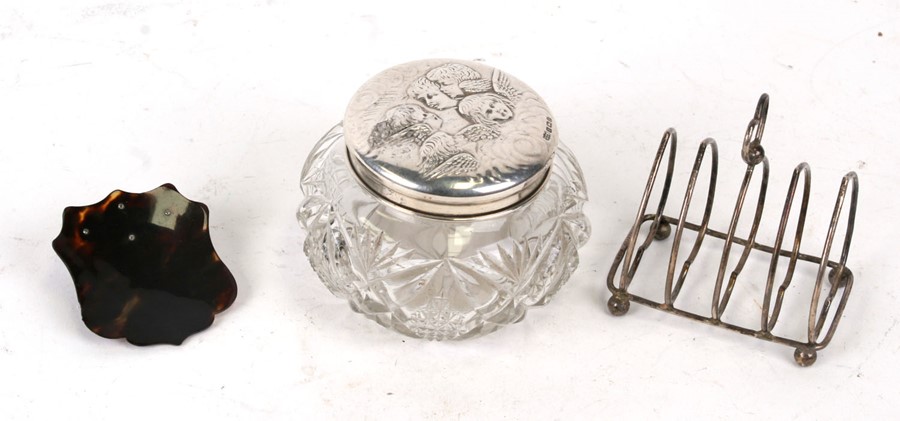 A silver topped cut glass dressing table jar decorated with angels, Birmingham 1926; together with a