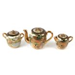 A late 19th / early 20th century Japanese Satsuma three-piece teaset decorated with figures in a
