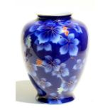 A 1920's Japanese Fukagawa vase decorated with berries and leaves on a blue ground, blue character