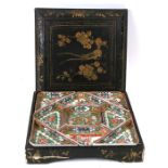 An early 20th century Chinese famille rose hor d'oeuvres set in a black lacquer box decorated with