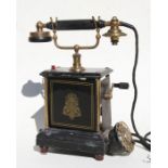 An early 20th century French wind-up telephone (a/f).