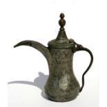 A Turkish or Islamic tinned brass dallah or coffee pot, 23cms (9ins) high.