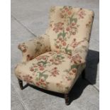 A late 19th century upholstered armchair, re-upholstered with Geoffrey Bennison fabric.