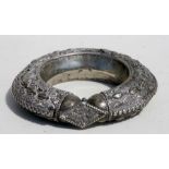 A white metal slave bangle, 12cms (4.75ins) diameter.