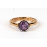 A 9ct gold dress ring set with a circular faceted cut amethyst, approx UK size 'P'. 4.1g