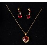 A 9ct gold diamond and red stone heart shaped pendant and earring set. 3.4g