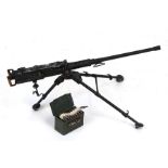 A metal model of a M2 Browning 50 calibre Machine Gun with tripod and belt fed ammunition in ammo